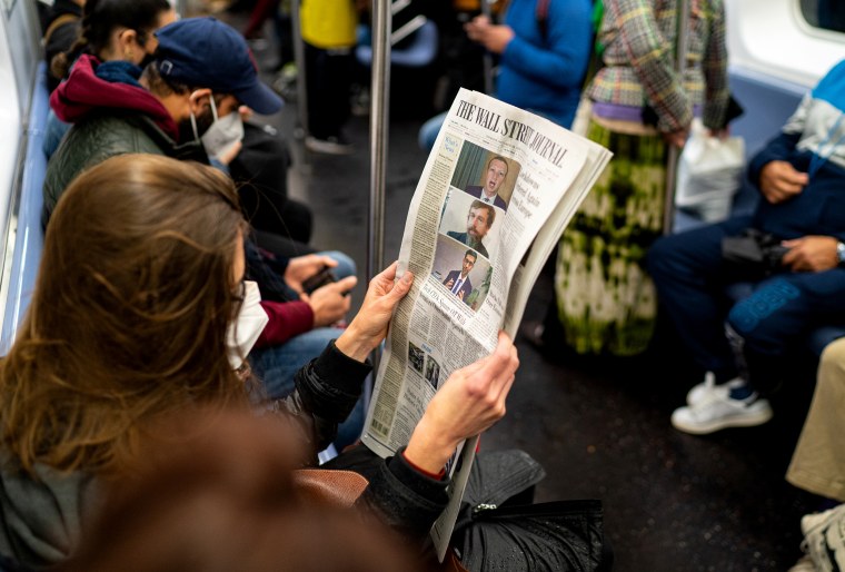 A passenger reads the front page of the Wall Street Journal on Oct. 29, 2020 in New York City.