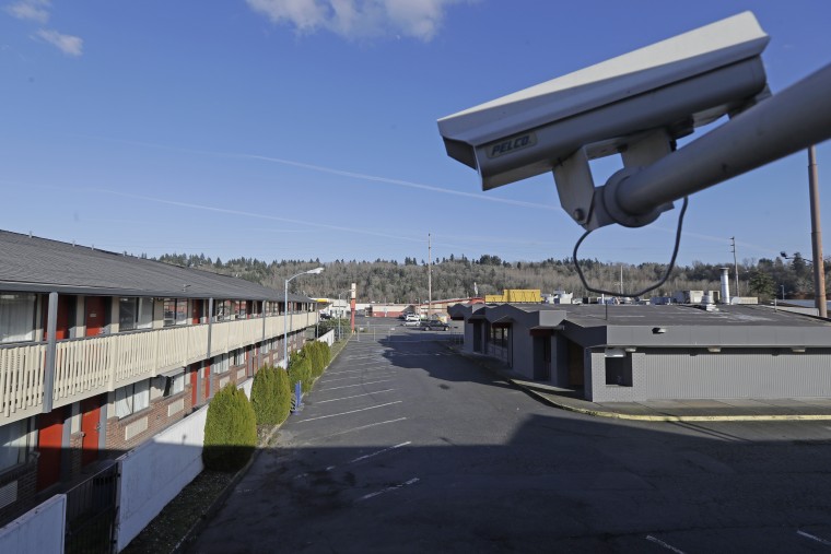 A security camera is shown on the second floor of a row of rooms at a motel in Kent, Wash on March 4, 2020. Hackers aiming to call attention to the dangers of mass surveillance said they were able to peer into hospitals, schools, factories, jails and corporate offices after they broke into the systems of a security-camera startup. That California startup, Verkada, said Wednesday, March 10, 2021,  it is investigating the scope of the breach, first reported by Bloomberg, and has notified law enforcement and its customers.