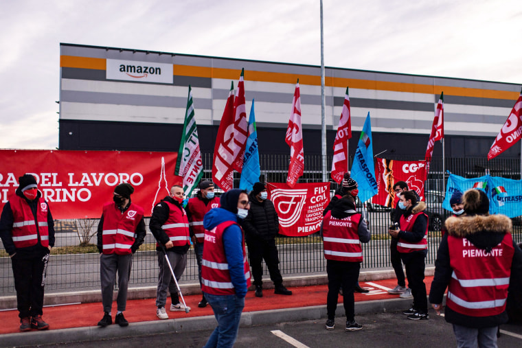 Amazon employees demonstrate for better working conditions outside a distribution center in Brandizzo, near Turin, Italy, on March 22, 2021.