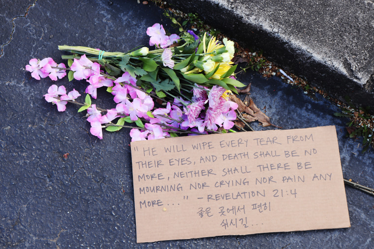Image: Flowers left in front of Gold Spa in Atlanta