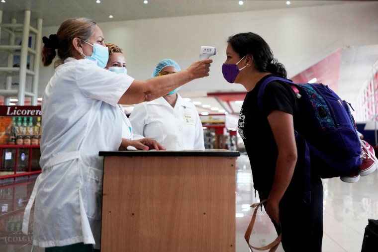 A traveler has her temperature checked at the Jose Marti International Airport in Havana on Nov. 15, 2020.