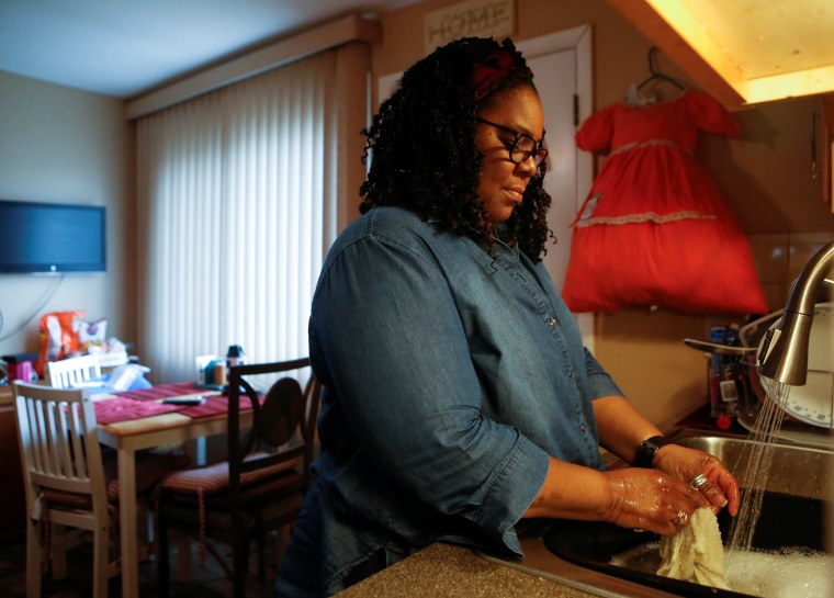 Image: Delois Robinson washes dishes at her home in Evanston, Ill