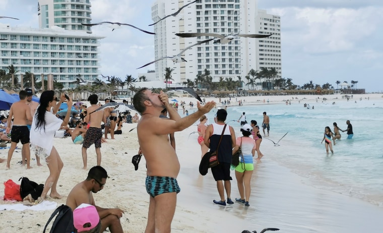 Tourists enjoy a public beach in Cancun, Mexico March 9, 2021.
