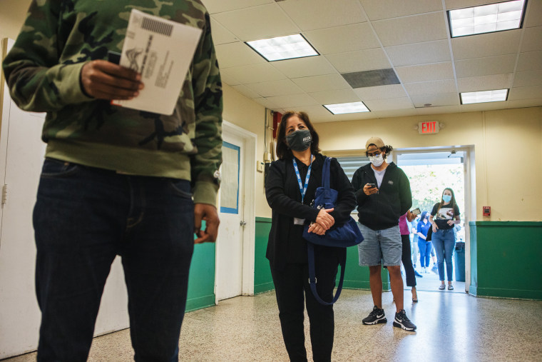 Voters wait in line at a polling location in Miami on Nov. 3, 2020.
