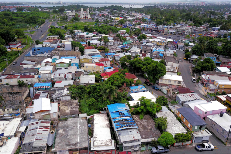 Image: Blue tarps given out by FEMA cover several roofs two years after Hurricane Maria affected the island in San Juan, Puerto Rico, on Sept. 18, 2019.