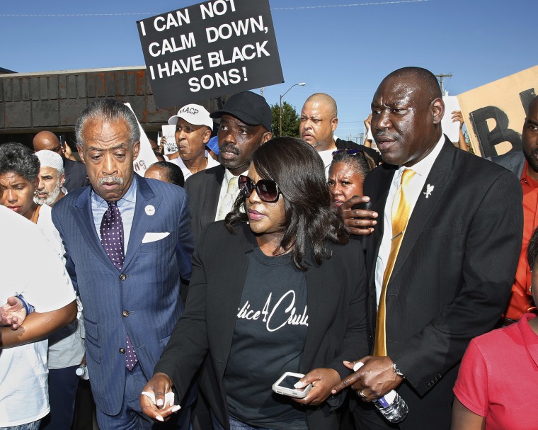 Tiffany Crutcher, center, the twin sister of Terence Crutcher, who was killed by a Tulsa police officer, marches with the Rev. Al Sharpton, left, and attorney Benjamin Crump, right, in Tulsa, Okla., on Sept. 27, 2016.
