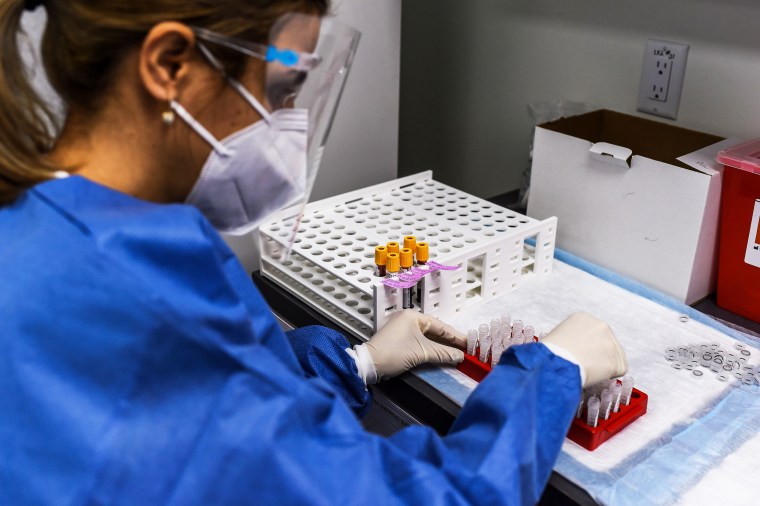 A lab technician sorts blood samples for Covid-19 vaccination studies at the Research Centers of America in Hollywood, Fla., on Dec. 18, 2020.