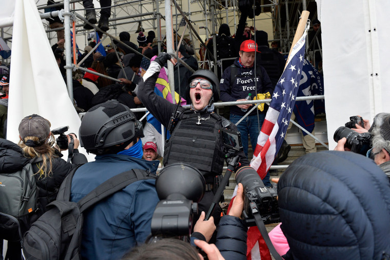 Image: A man calls on people to raid the building as Trump supporters clash with police and security forces as they try to storm the Capitol