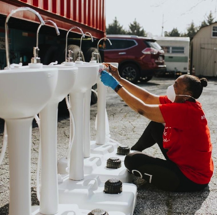 Image: Pamela Hill-Wright works on Loves Sinks In, portable units