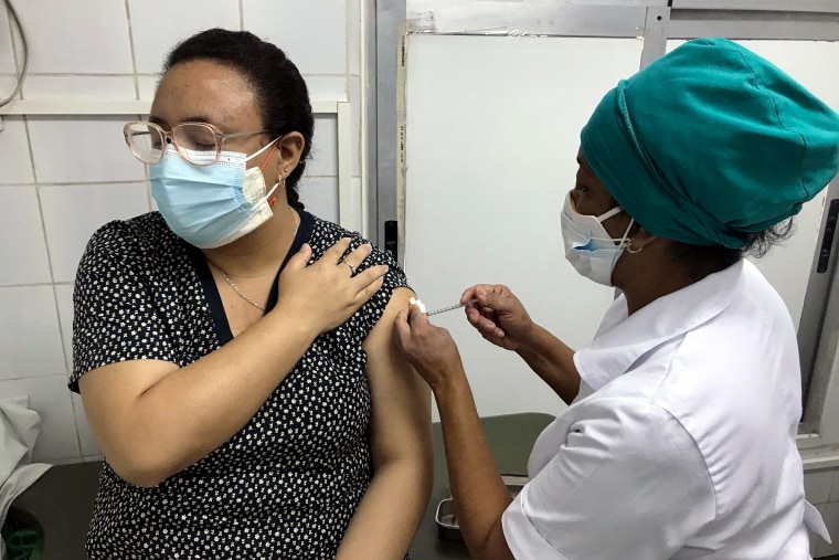 A worker at Cuba’s Vedado Policlinic gets a shot as part of an interventional study of Cuba’s Soberana 2 experimental Covid vaccine, which is in late phase trials, on March 24, 2021.