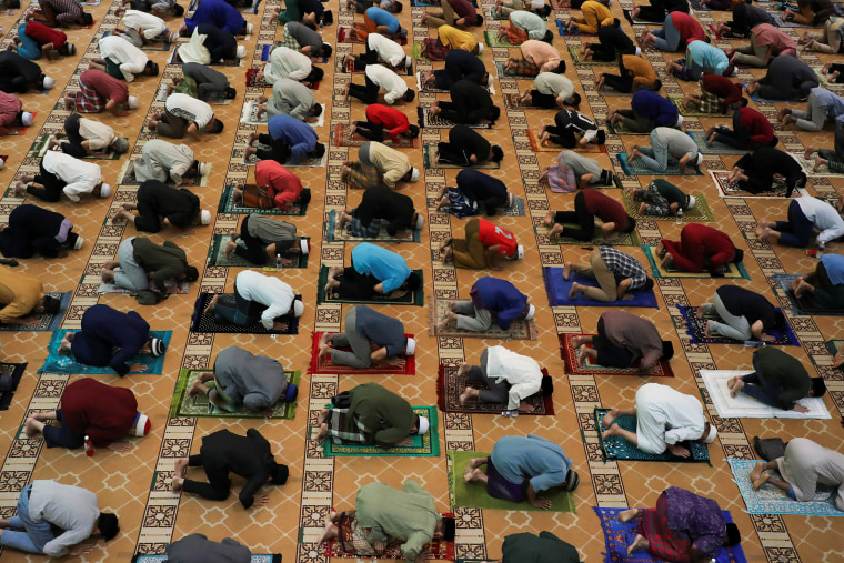 Image: Worshippers pray while social distancing on the first day of Ramadan, in Kuala Lumpur, Malaysia, on April 13, 2021.