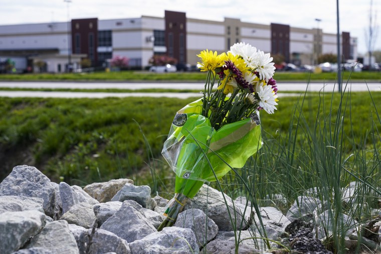 A single bouquet of flower sits across the street from the FedEx facility in Indianapolis on April 17, 2021, where eight people were shot and killed.