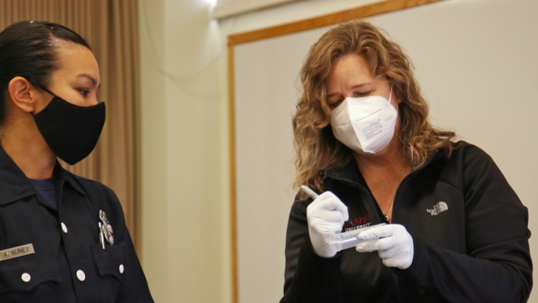 Mary Prunicki labels a sample collected from a firefighter.