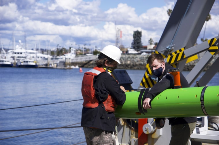 Researchers aboard the research vessel Sally Ride recover an autonomous underwater vehicle after a search for discarded barrels near Santa Catalina Island, Calif., on March 11, 2021.