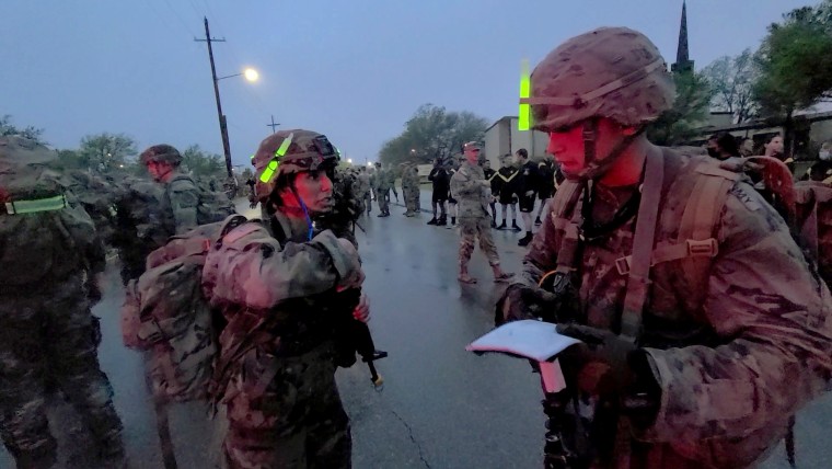 1st Lt. Maria Eggers completes a functions check on her weapon just before crossing the finish line of the culminating event, a 12-mile Foot March on April 16 at Fort Hood, Texas.