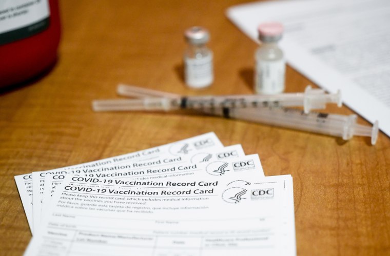 Blank CDC-issued Covid-19 vaccination record cards are set out on a table at the Berks Heim Nursing and Rehabilitation Center in Bern Township, Pa., on Jan. 29, 2021.