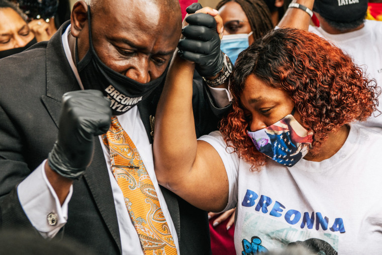 Attorney Ben Crump and Tamika Palmer, mother of Breonna Taylor, celebrate after a news conference on Sept. 15, 2020 in Louisville, Ky., after it was announced that the city of Louisville will institute police reforms and pay $12 million to the family for Breonna's killing by police.