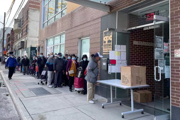 Image:  Asian seniors line up to get free safety alarms distributed by the nonprofit Asians in America in Flushing, N.Y., last month.