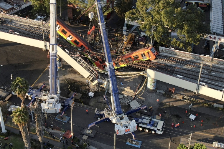 Image: Subway cars dangle at an angle from a collapsed elevated section of the metro, in Mexico City on May 4, 2021.