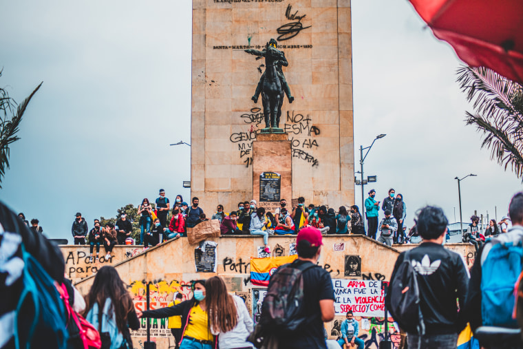 Protesters gather around a statue of Simon Bolivar in Bogota on Wednesday.