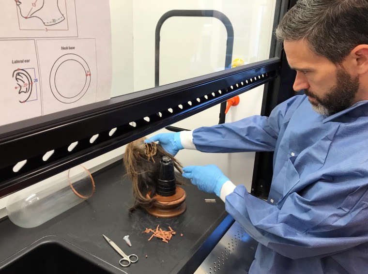 Mercer University biologist and anthropologist Craig Byron examines the tsantsa to verify its authenticity before it was repatriated to Ecuador.