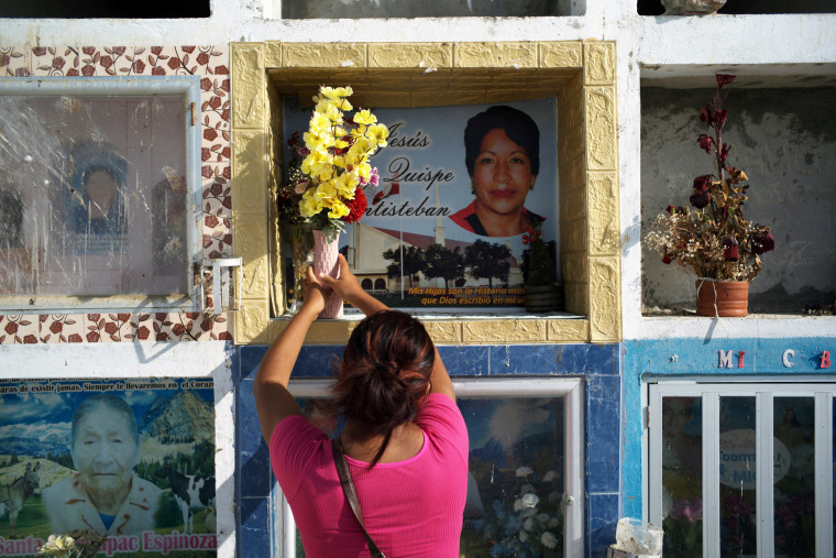 Hellen Nanez visits the grave of her aunt who died in June last year of Covid-19 in Pisco, Peru, on May 9, 2021.