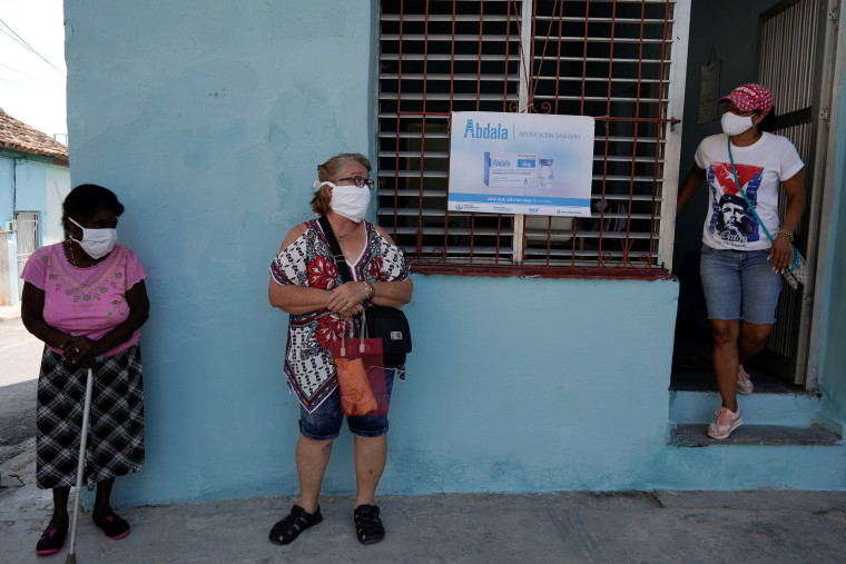 Image: People wait in line to enter a vaccination center in Havana on May 12, 2021.