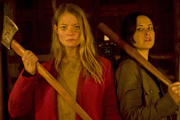 Sarah Allen, left and Tommie-Amber Pirie in "The Retreat" play a couple who spend a romantic weekend at a remote cabin in the woods. They end up having to fight for their lives.