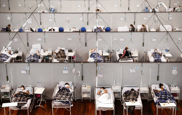 Image: Patients suffering from Covid-19 rest while being treated at a field hospital in a sports complex on May 17, 2021 in Santo Andre, Brazil.
