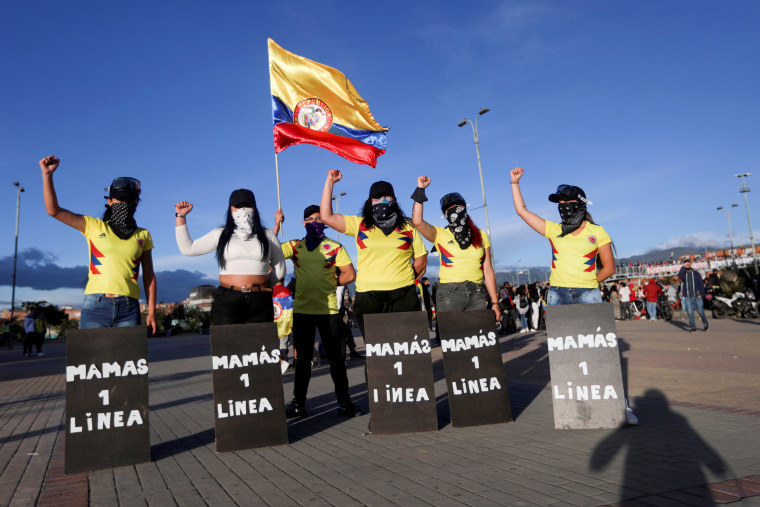 Image: Women with protective shields that read "Mothers of the first line" pose for a photo during a protest demanding government action to tackle poverty, police violence and inequalities in healthcare and education systems, in Bogota