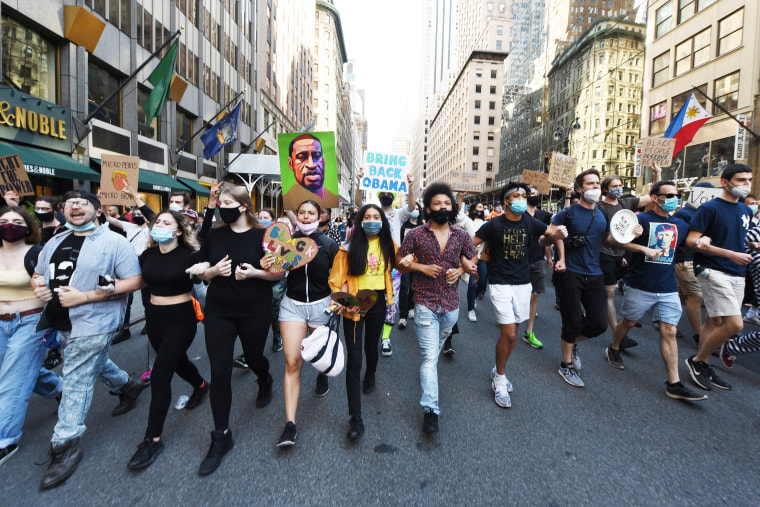 Demonstrators lock arms and march during a protest in New York on June 14, 2020, following George Floyd's death.