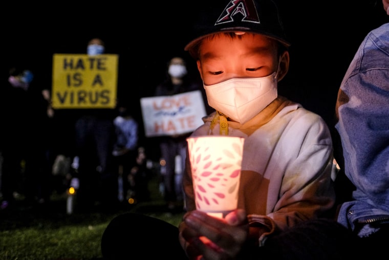 Lael Choi holds a candle during a  vigil in solidarity with the Asian American and Pacific Islander communities at Almansor Park in Alhambra, Calif., on March 20, 2021.