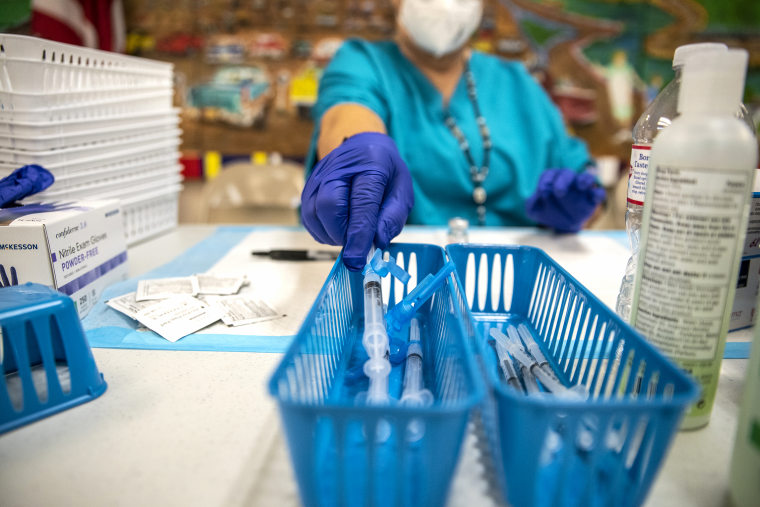 A nurse fills up a syringe with the Moderna Covid-19 vaccine at a vaccination site at a senior center on March 29, 2021 in San Antonio, Texas.