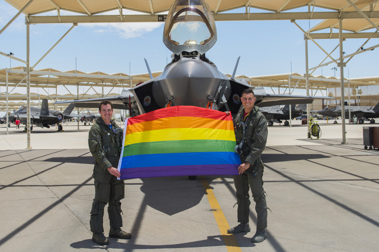 Maj. Tyler McBride and Capt. Justin Lennon hold a Pride flag after a Pride Month flyby on June 26, 2020, at Luke Air Force Base, Ariz.