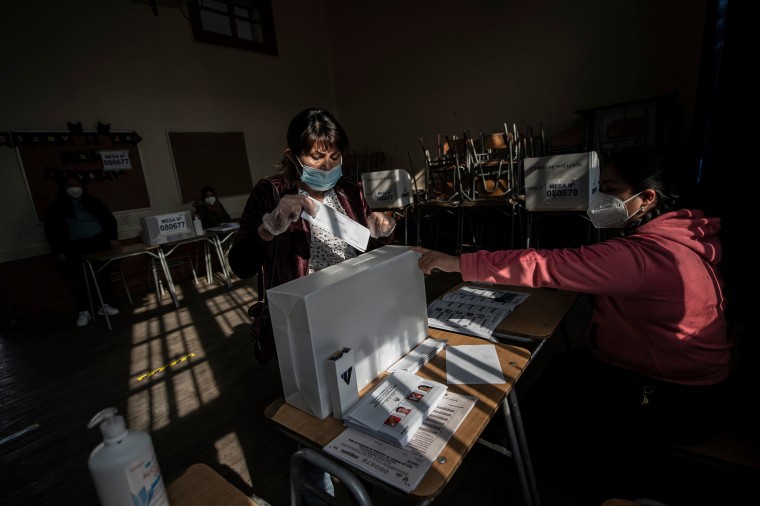 Image: A voter casts her ballot at a polling station in Santiago, Chile on June 6, 2021.