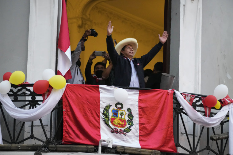 Presidential candidate Pedro Castillo greets supporters while celebrating partial election results that show him leading over Keiko Fujimori at his campaign headquarters in Lima, Peru, on June 7, 2021.