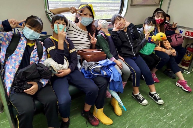 Sunny Huang, center, recently moved to Taiwan, where she works with children.