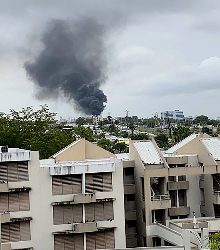 Smoke billows after a large fire at a main substation that left hundreds of thousands of clients in the dark in San Juan, Puerto Rico on June 10, 2021.