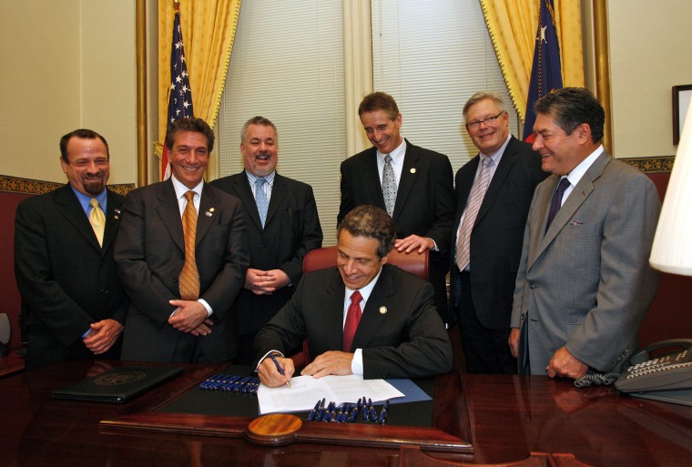 Image: Gov. Andrew Cuomo signs the Marriage Equality Act, with Harry Bronson, Matthew Titone, Daniel O'Donnell, Bob Duffy, Tom Duane and James Alesi, on June 24, 2011.