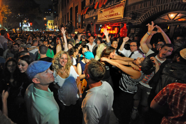 People celebrate in front of the Stonewall Inn after the passing of the state's same sex marriage bill in New York, on June 24, 2011.