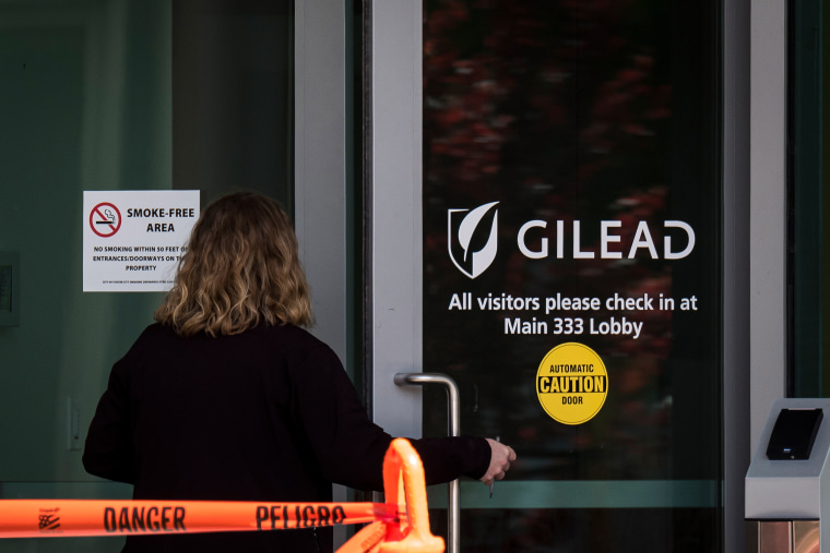 Image: A person enters a building at Gilead Sciences Inc. headquarters in Foster City, Calif., on March 19, 2020.