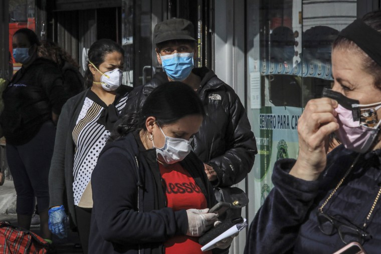 People in Sunset Park, a Brooklyn neighborhood with one of New York''s largest Mexican and Hispanic communities, wear masks while waiting in line at the height of the pandemic in May, 2020.