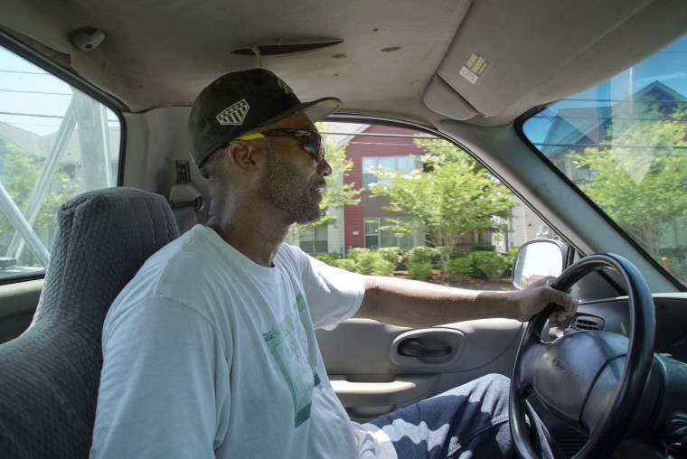Image: Alton Lucas drives home after dropping some firewood at a local convenience store outside of Raleigh, N.C., on June 18, 2021.