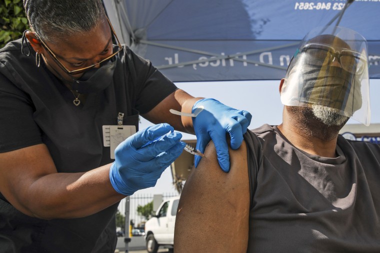 A health worker administers a Pfizer Covid-19 vaccination at a mobile vaccination clinic in Los Angeles on July 16, 2021.