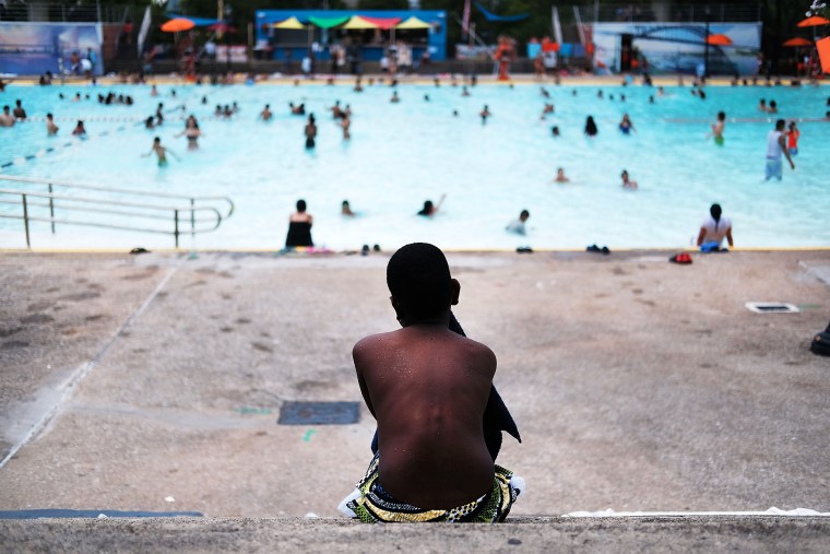 Image: A child takes a break from swimming at the Astoria Pool in Queens, N.Y., on June 29, 2016.