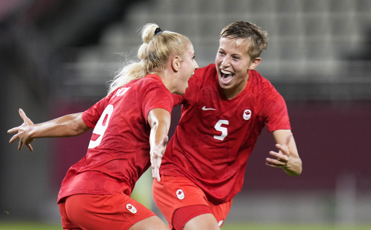 Canada's Adriana Leon, left, celebrates with teammate Quinn after scoring her side's opening goal against Great Britain during a women's soccer match at the Tokyo Games on July 27, 2021.