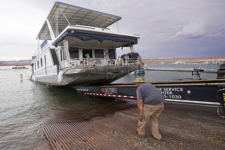 A family's houseboat is pulled from the Wahweap launch ramp after a three-week vacation.