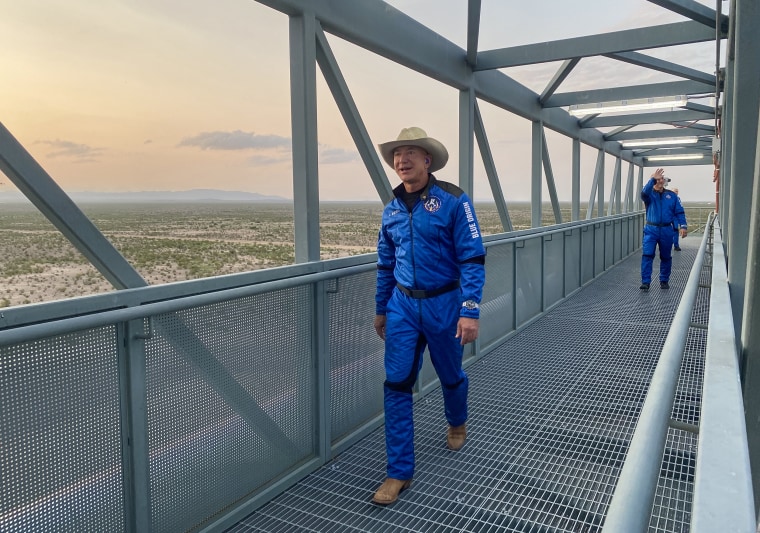 Jeff Bezos walks across the crew access gantry to enter into the crew capsule for flight on July 20, 2021.