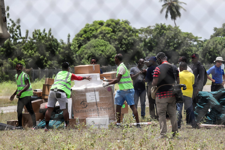 Image: Workers unload humanitarian aid from a U.S. helicopter at Les Cayes airport in Haiti, Aug. 18, 2021.