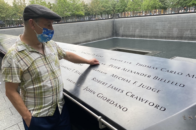 Brendan Fay at a 9/11 Memorial where Father Mychal Judge's name is displayed.